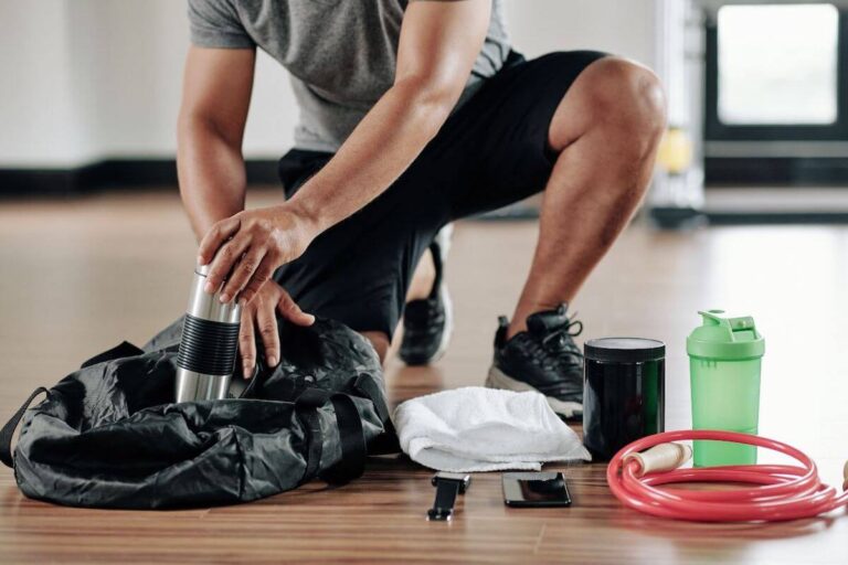 close shot of a gym bag, a person putting his accessories in his gym bag.