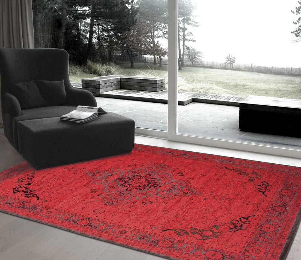 picture taken of a area rug, a sofa and window in background.